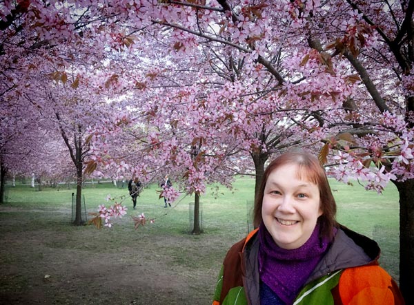 Paivi Eerola in a flowering cherry tree park.