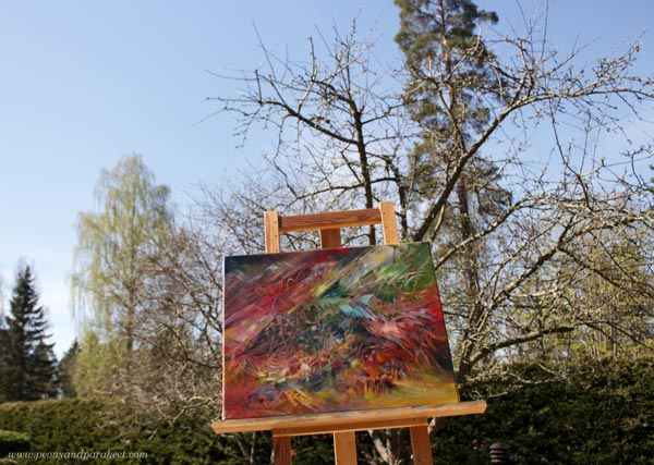 "Finch" - an oil painting by Paivi Eerola, photographed against the sky.