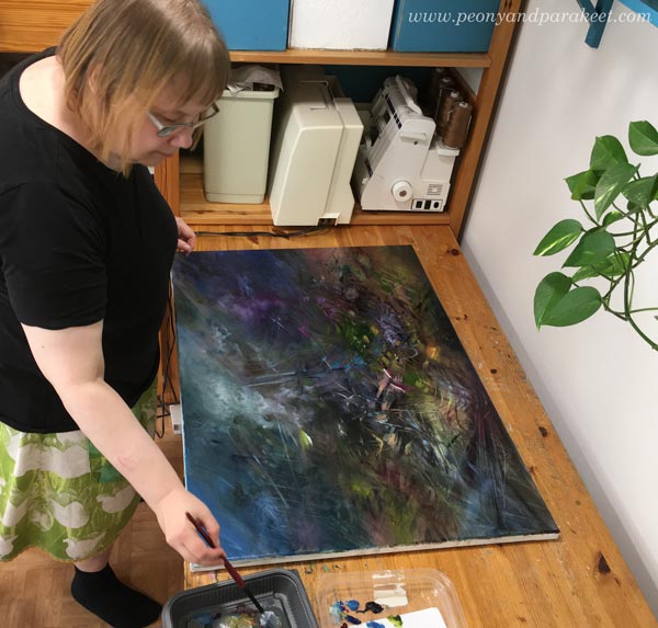 Paivi Eerola painting with oils. The painting is upside down.