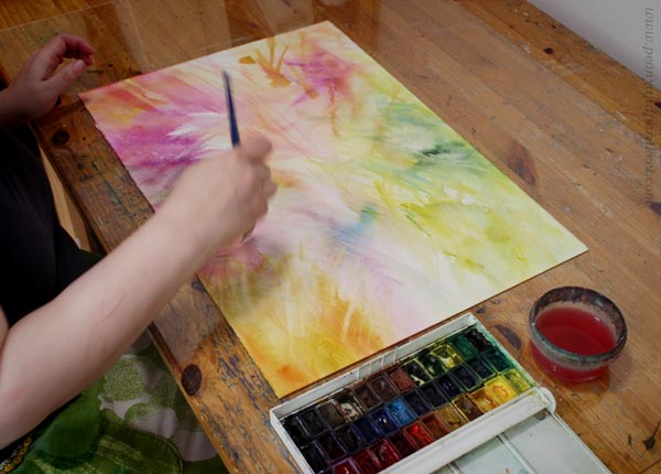 Working in a studio as a watercolor artist. Concentration is a part of artist's life.