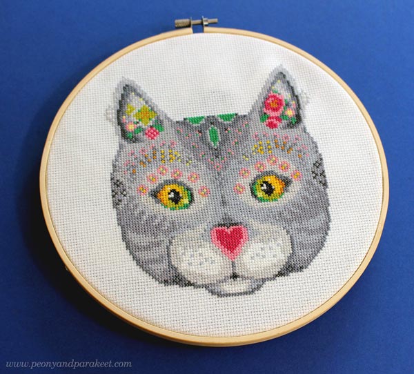 Magical Cat framed in a hoop. Designing a cross stitch pattern