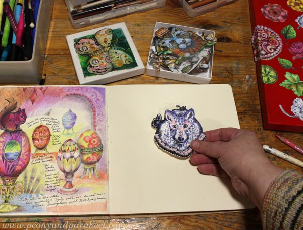 Selecting a picture prompt for an art journal page. Creative art journaling.