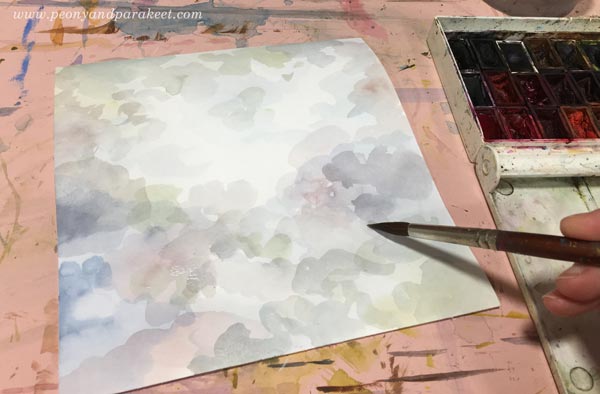 Painting a background to bring out a watercolor collage flower.